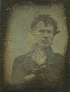 Taken in 1839 by an amateur chemist and photography enthusiast from Philadelphia named Robert Cornelius. Cornelius had set his camera up at the back of the family store in Philadelphia. He took the image by removing the lens cap and then running into frame where he sat for a minute before covering up the lens again. On the back he wrote “The first light Picture ever taken. 1839.” 